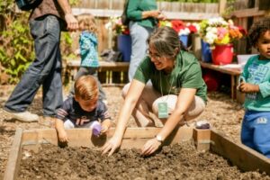 adult and child playing in soil